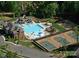Aerial view of community pool, tennis courts, waterslides, and ample parking at 1005 Forbishire Dr, Matthews, NC 28104