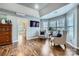 Cozy sitting room featuring hardwood floors, large windows, and comfortable chairs for a relaxing and inviting atmosphere at 1005 Forbishire Dr, Matthews, NC 28104