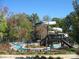 Community waterslide with winding river, mature landscaping, and lush trees at 1005 Forbishire Dr, Matthews, NC 28104