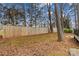 View of a tall backyard wooden fence and mature trees at 101 Fairfax Dr, Salisbury, NC 28146