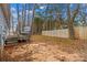 Backyard features a small deck and is surrounded by mature trees and foliage at 101 Fairfax Dr, Salisbury, NC 28146