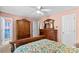 Spacious bedroom boasts a wooden bed frame, elegant dresser, and natural light from the window at 101 Fairfax Dr, Salisbury, NC 28146