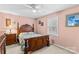 Comfortable bedroom featuring a wooden bed frame, matching dresser, and a ceiling fan at 101 Fairfax Dr, Salisbury, NC 28146