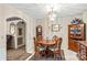 Charming dining area featuring wooden furniture, floral wallpaper, and a decorative chandelier at 101 Fairfax Dr, Salisbury, NC 28146