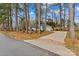 Charming exterior view of a light blue home with a long driveway and a backdrop of tall, mature trees at 101 Fairfax Dr, Salisbury, NC 28146