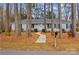 Charming home with light blue siding, black shutters, and a covered front porch nestled among towering pine trees at 101 Fairfax Dr, Salisbury, NC 28146