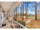 View from the covered front porch overlooking mature trees and the front yard showcasing the property's curb appeal at 101 Fairfax Dr, Salisbury, NC 28146