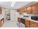 Classic kitchen featuring oak cabinetry, white appliances, and a layout that includes both cooking and laundry areas at 101 Fairfax Dr, Salisbury, NC 28146