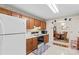 Traditional kitchen with wooden cabinets, standard appliances, and an open view to a dining area for easy entertaining at 101 Fairfax Dr, Salisbury, NC 28146