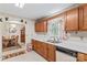 Cozy kitchen offering wood cabinets, standard appliances, and a clear view into the dining room with charming decor at 101 Fairfax Dr, Salisbury, NC 28146