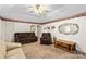 Inviting living area featuring a ceiling fan, patterned wallpaper border, and comfortable seating arrangement at 101 Fairfax Dr, Salisbury, NC 28146