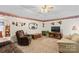 Cozy living room features plush seating, decorative wallpaper border, and a classic ceiling fan at 101 Fairfax Dr, Salisbury, NC 28146