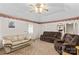Bright living room with comfortable seating, neutral carpet, and a vaulted ceiling with a fan at 101 Fairfax Dr, Salisbury, NC 28146
