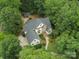Stunning aerial view of a secluded estate home with lush landscaping and a charming detached structure at 1025 Seminole Dr, Waxhaw, NC 28173