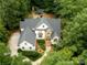 Aerial view of the home, landscaped yard and patio with outdoor fireplace and bar at 1025 Seminole Dr, Waxhaw, NC 28173