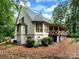 Charming back exterior view with covered porch, well-maintained landscaping, and stone accents at 1025 Seminole Dr, Waxhaw, NC 28173