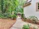 Inviting outdoor living area with stone fireplace and bar seen from gated backyard at 1025 Seminole Dr, Waxhaw, NC 28173