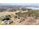 An expansive aerial view capturing a neighborhood near a scenic lake, showcasing lush greenery and surrounding landscape at 108 Outside Loop Ln, Mooresville, NC 28117