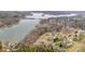 Picturesque aerial view of a waterfront community with homes nestled among trees along the serene lake shoreline at 108 Outside Loop Ln, Mooresville, NC 28117