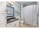 Cozy bathroom featuring a vanity with granite top, toilet, and shower-tub combo with tiled flooring and shower curtain at 108 Outside Loop Ln, Mooresville, NC 28117