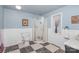 Bathroom with a glass shower, toilet, black and white checkered floor, and wainscoting at 108 Outside Loop Ln, Mooresville, NC 28117