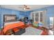 Bedroom with natural light, a bed, desk, ceiling fan, and hardwood floors, offering a cozy space at 108 Outside Loop Ln, Mooresville, NC 28117