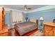 Comfortable bedroom with a large window, ceiling fan, hardwood floors and a queen-sized bed at 108 Outside Loop Ln, Mooresville, NC 28117