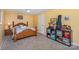 Bedroom featuring a wooden bed frame, beige carpet, and yellow walls at 108 Outside Loop Ln, Mooresville, NC 28117