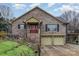 Brick home with a red front door, shuttered windows, and a two-car garage at 108 Outside Loop Ln, Mooresville, NC 28117