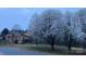Beautiful home featuring an outdoor deck and lovely flowering trees in the yard at 108 Outside Loop Ln, Mooresville, NC 28117