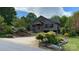 Charming brick home with a well-manicured lawn and beautiful landscaping at 108 Outside Loop Ln, Mooresville, NC 28117