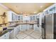 Well-equipped kitchen with white cabinets, tile backsplash, stainless steel appliances, and tiled flooring accents at 108 Outside Loop Ln, Mooresville, NC 28117