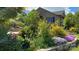 Lush landscaping and flower beds in front of a brick home in a well-maintained neighborhood at 108 Outside Loop Ln, Mooresville, NC 28117