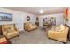 Cozy basement living room with comfortable seating, carpet, a bookshelf, and a game table for entertaining at 108 Outside Loop Ln, Mooresville, NC 28117