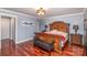 Spacious main bedroom featuring wood floors, a large bed, side tables, and a ceiling fan for comfort at 108 Outside Loop Ln, Mooresville, NC 28117