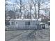 Charming single-story home featuring a metal roof, inviting front porch, and well-maintained gravel landscaping at 110 Shawnee Trl, Mount Gilead, NC 27306