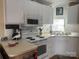 Well-lit kitchen showcases white cabinets, modern appliances, and a practical layout for easy cooking at 110 Shawnee Trl, Mount Gilead, NC 27306
