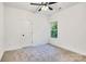 This bedroom has neutral carpet, a ceiling fan and a window with green outdoor view at 117 Lippard St, Statesville, NC 28677