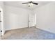 Bright bedroom with neutral carpet, ceiling fan, and white trim ready for personalization at 117 Lippard St, Statesville, NC 28677