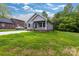 Inviting home with lush green lawn, gray siding, and well-maintained landscaping at 117 Lippard St, Statesville, NC 28677