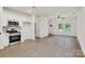 Open concept living space with neutral walls, hardwood floors, and modern kitchen at 117 Lippard St, Statesville, NC 28677