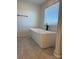 Bright bathroom with a contemporary freestanding tub and view of a window at 1300 Austin Chaney Rd, Wingate, NC 28174