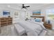 Well-lit bedroom featuring a ceiling fan, hardwood floors, and sunny windows at 1300 Austin Chaney Rd, Wingate, NC 28174