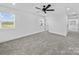 Spacious carpeted bedroom with ceiling fan, and a large window at 1300 Austin Chaney Rd, Wingate, NC 28174