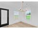 Dining area with modern chandelier, wood floors, and large windows with green views at 1300 Austin Chaney Rd, Wingate, NC 28174
