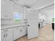 Modern kitchen with white cabinets, stainless steel appliances and light wood flooring at 1300 Austin Chaney Rd, Wingate, NC 28174