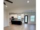 Open-concept kitchen featuring a black island, white cabinetry, and modern appliances at 1300 Austin Chaney Rd, Wingate, NC 28174