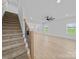 The living room features stairs, a hardwood floor, and lots of natural light at 1300 Austin Chaney Rd, Wingate, NC 28174