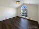 Bright bedroom with vaulted ceiling, modern light fixture and gorgeous arched window at 161 Kilborne Rd, Mooresville, NC 28117