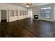 Open living room featuring built-in bookshelves, a cozy fireplace, and modern flooring at 161 Kilborne Rd, Mooresville, NC 28117